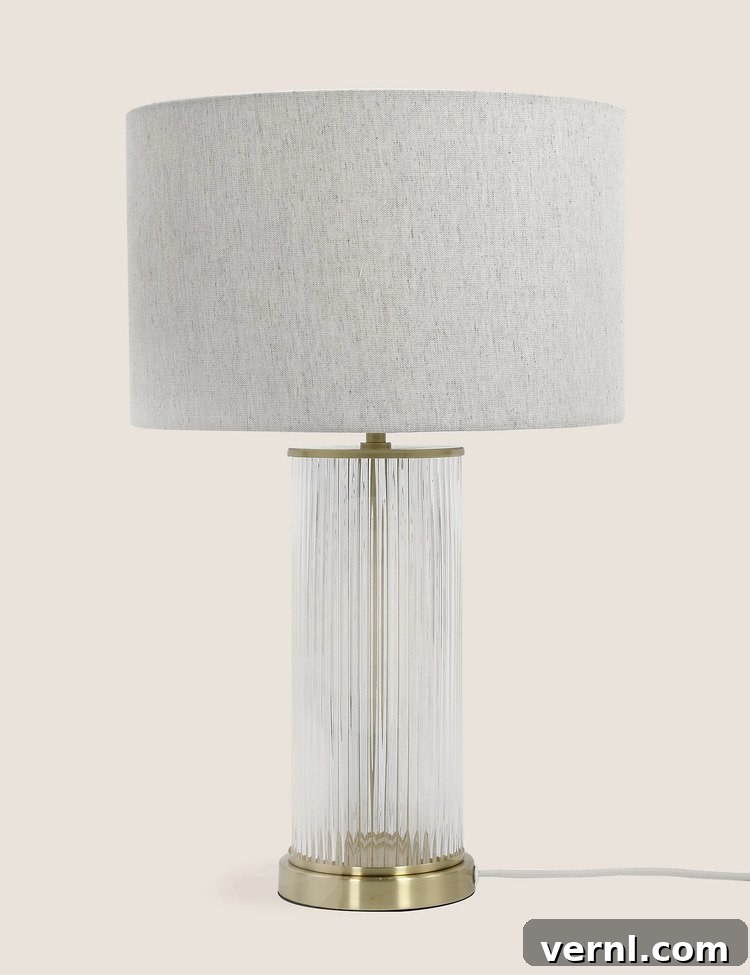 10 Elegant Glass Table Lamps to Brighten Your Home 4 A ribbed glass table lamp with brass details.