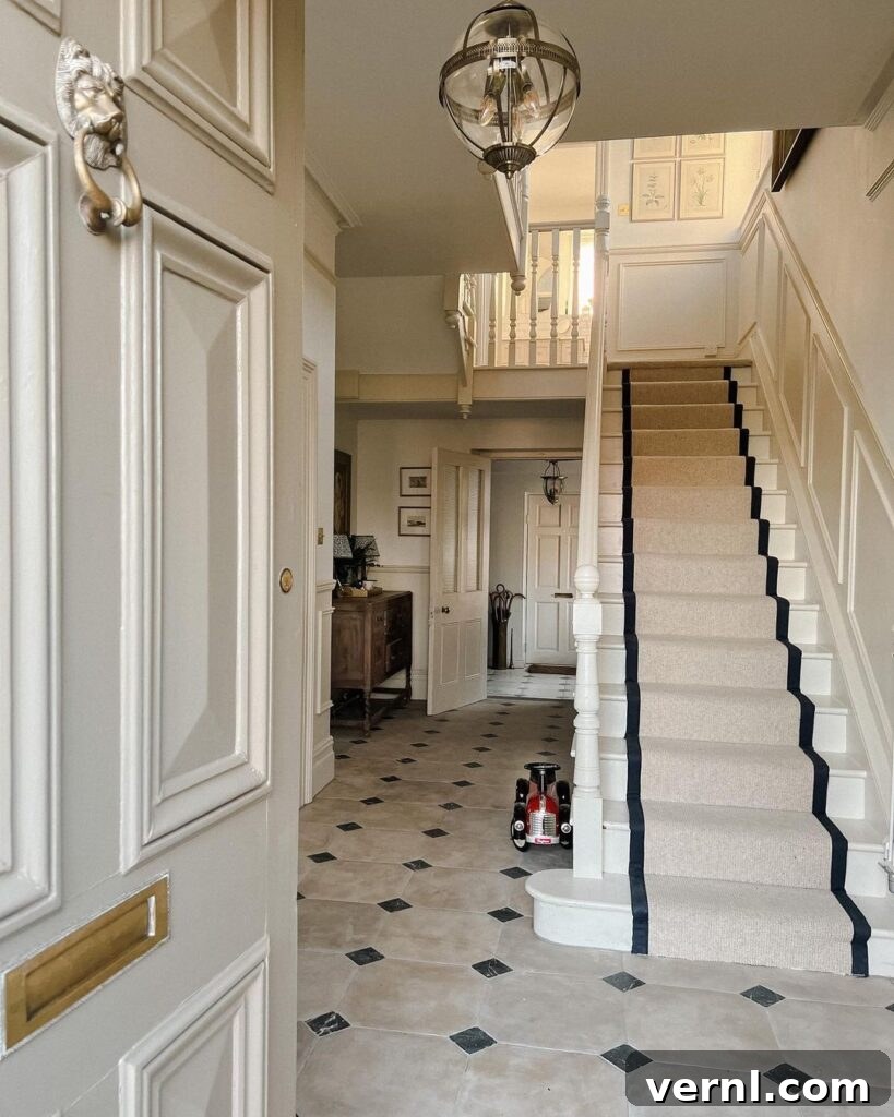 Hallway, Staircase and Landing Design Ideas for an Elegant Home 2 Elegant hallway with a classic staircase, neutral tones, and black-accented runner, offering timeless hallway ideas for home design.