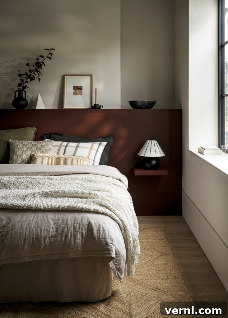 A cosy bedroom with a warm bedroom aesthetic. The bed is dressed with seersucker bedding and the colour tones are warm and autumnal.