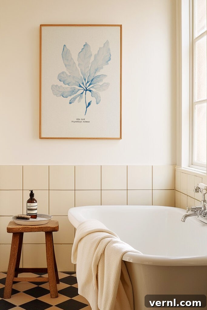 8 Interior Design Trends and Terms to Know in 2025 8 A blue watercolour seaweed art print in a calm cream bathroom.
