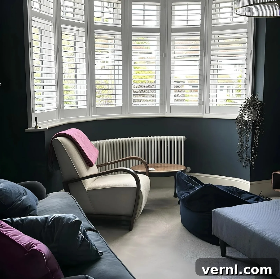 Unique Radiator Designs to Transform Your Home Renovation 2 A curved bay window radiator in a blue living room.