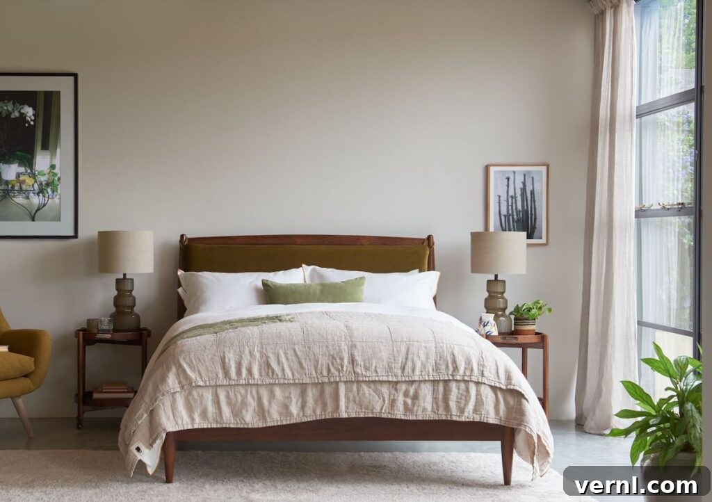 Why Odd Numbers Improve Design: Styling in 3s and 5s 5 A stylish mid-century bedroom with a wooden bed, cozy neutral linens, and framed artwork, featuring soft lighting and natural textures.