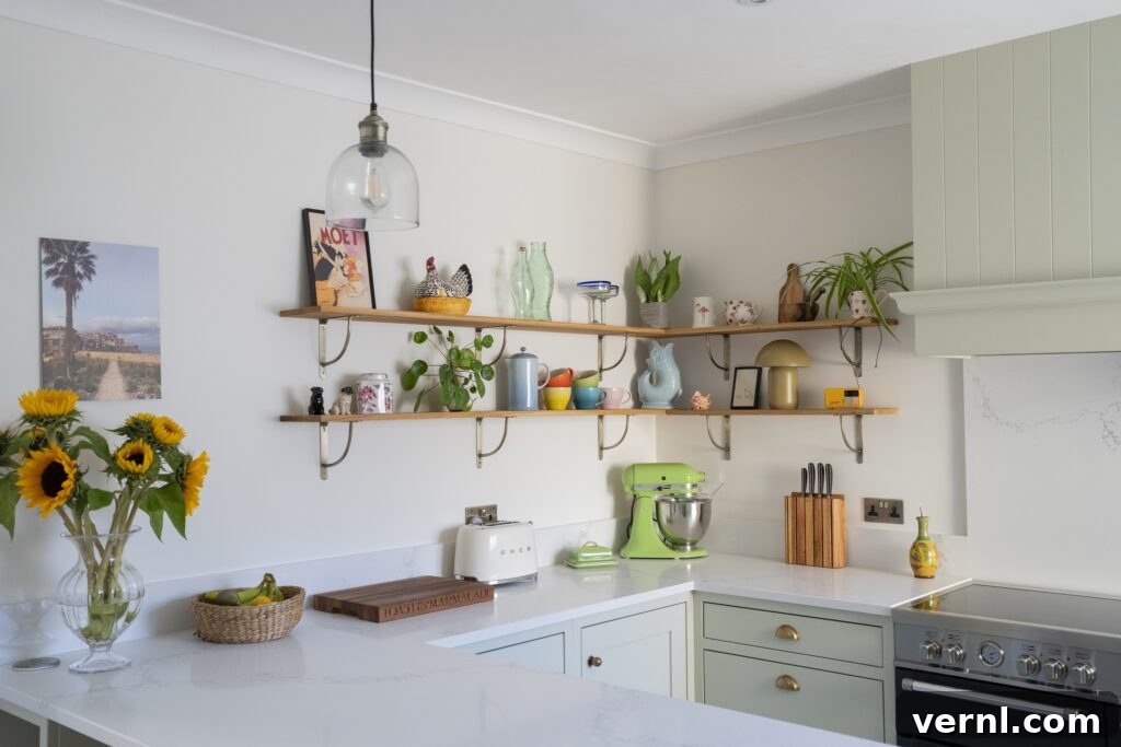 10 Clever Small Kitchen Ideas to Maximize Space and Function 4 A charming small kitchen featuring pastel cabinetry, open shelving adorned with plants and decor, a modern countertop, and bright accents, showcasing creative small kitchen ideas.