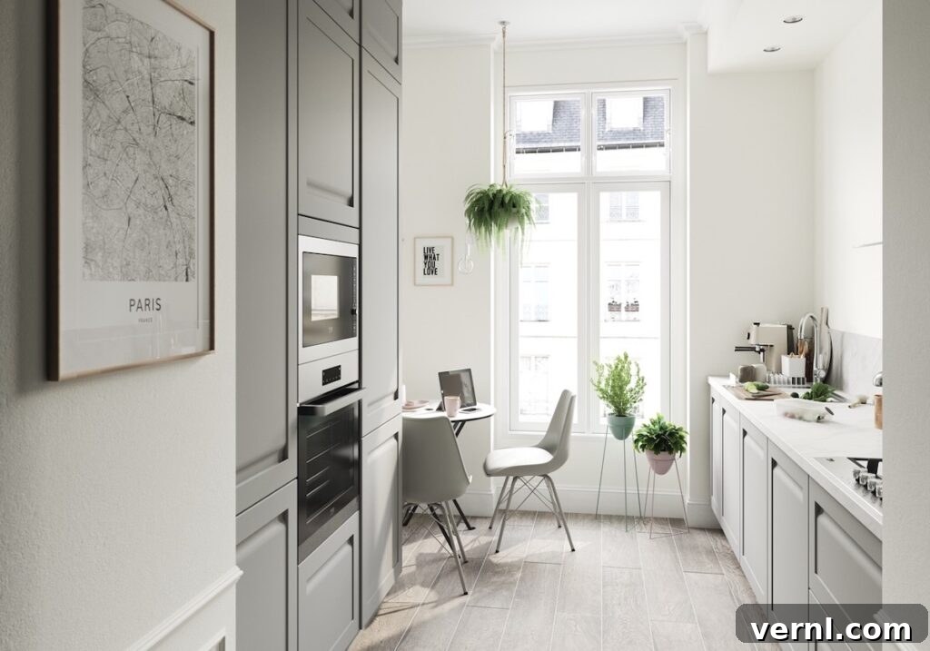 10 Clever Small Kitchen Ideas to Maximize Space and Function 9 Elegant small kitchen flooded with natural light, featuring grey cabinetry and modern details.