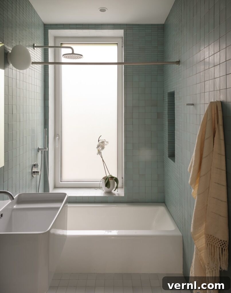 Brooklyn Row House Renovation for Modern Family Living 4
Green tiled bathroom with built-in tub, modern fixtures, and frosted window.