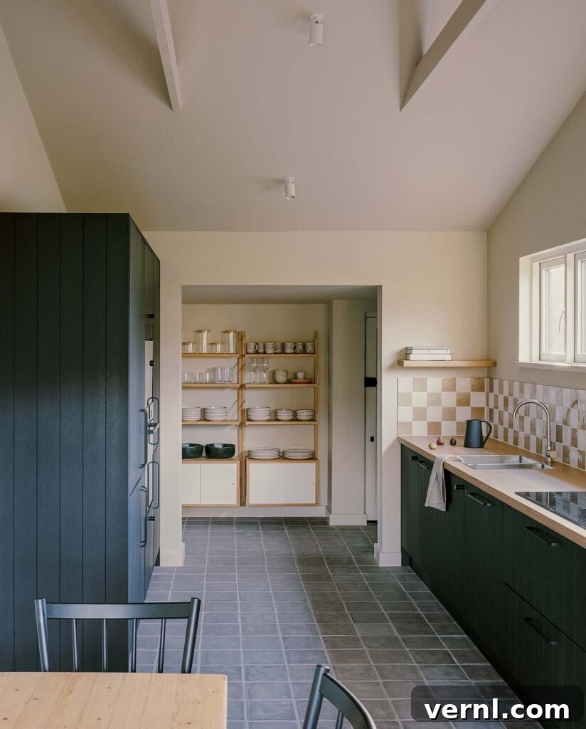 Inside a Dorset Beach House: Modern Coastal Living 5 Minimalist kitchen with open shelving and tiled backsplash.