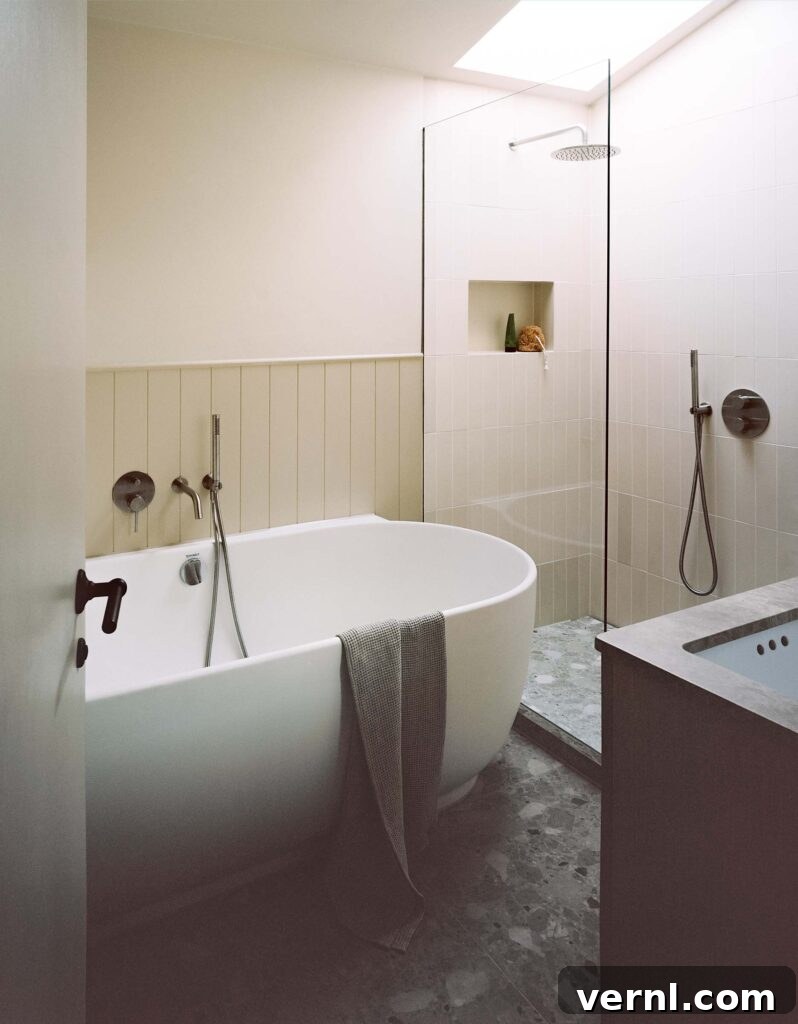 Inside a Dorset Beach House: Modern Coastal Living 8 Bright bathroom with freestanding tub and walk-in shower under skylight