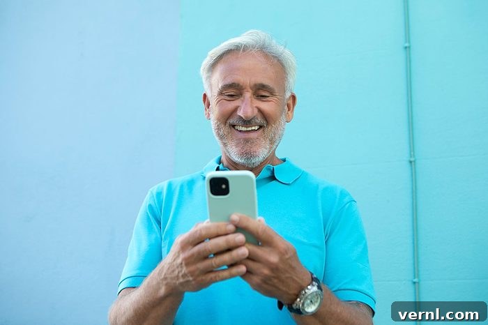 Cheerful mature man using a smart phone